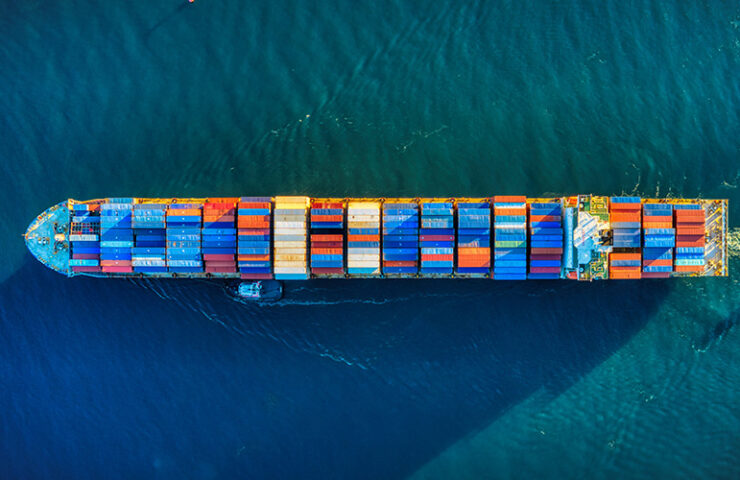 image of a large container ship, used as a blog post banner that is written about existing shipping delays under the title of covid-19 update as of june 2021